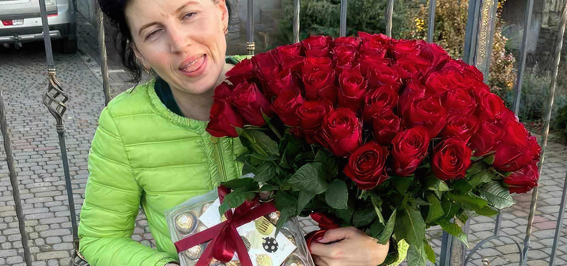 девушка с большим букетом красных роз.